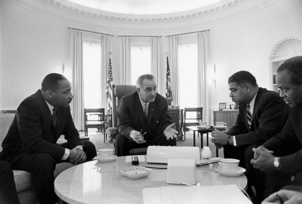 President Lyndon B. Johnson meets with civil rights leaders Rev. Martin Luther King Jr. (left), Whitney Young, and James Farmer in the Oval Office in 1964. (Image: Wikipedia)