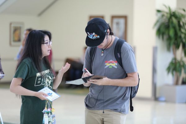 Iris collecting signatures at the University of South Florida for a petition urging the release of her mother. (Image: Hill Liu)