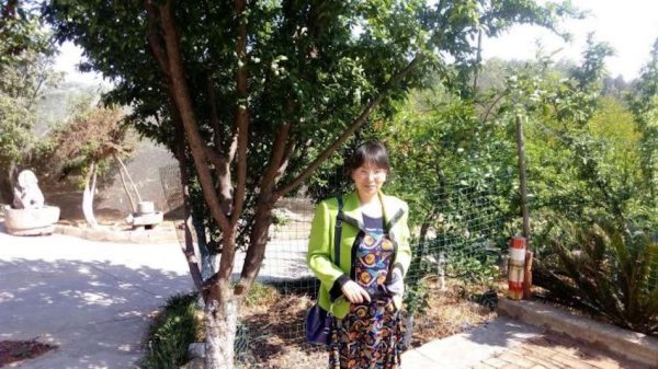 Iris's mother - Deng Cuiping, during spring time, in a local orchard of Yuxi city. (Image: Family Photo)