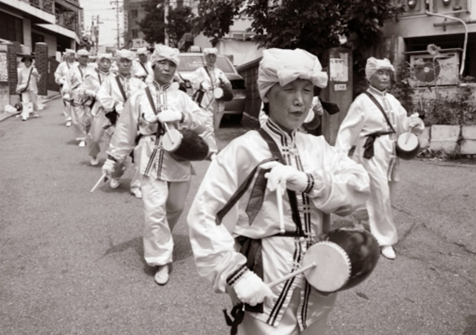 Korean Falun Gong practitioners do waist drum performances in a parade - the practitioners in Korea put in a lot of effort for the release of Chengnu. (Image via Jarrod Hall Vimeo/Screenshot)