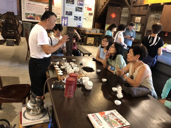 The operator of a hundred-year-old tea shop explain the history of the Oriental Beauty Tea to visitors (Image: Billy Shyu/ Nspirement)