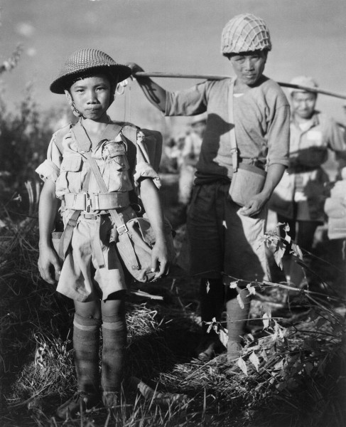 A Chinese Nationalist soldier, age 10, member of a Chinese division from the X Force, boarding planes in Burma bound for China, May 1944. (Image: via wikipedia / CC0 1.0)