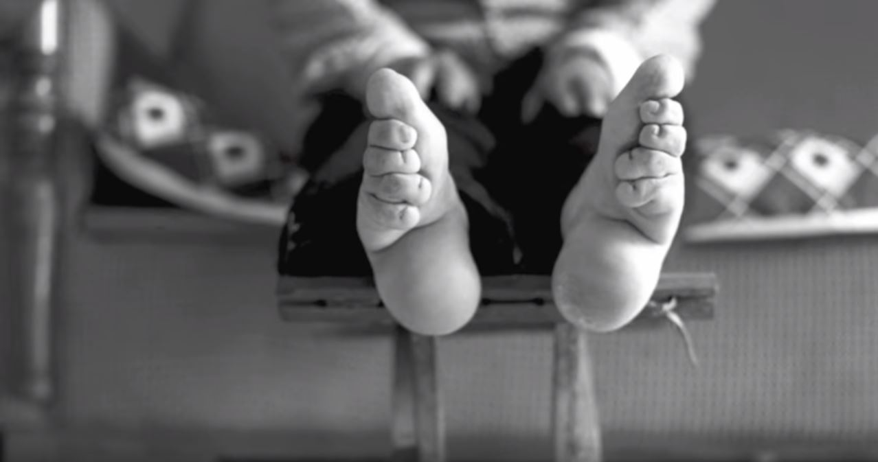 The binding would be so tight the girl could not move her toes at all. The ends of the binding cloth were even sewn so that the girl could not loosen it. (Image: YouTube/Screenshot via Living History: Bound Feet Women of China)