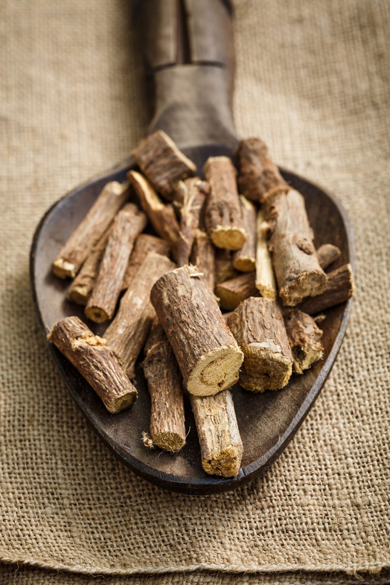 Licorice root in a wooden spoon.