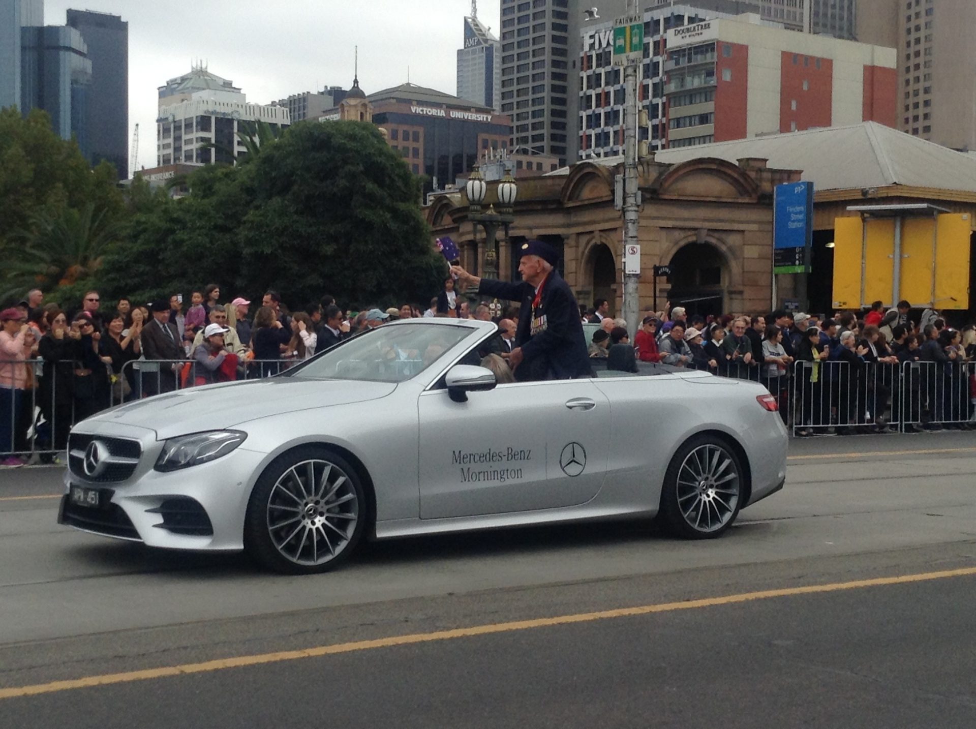Photo by Trisha Haddock of Soldier waving to crowd in Anzac Day march in Melbourne 2018.