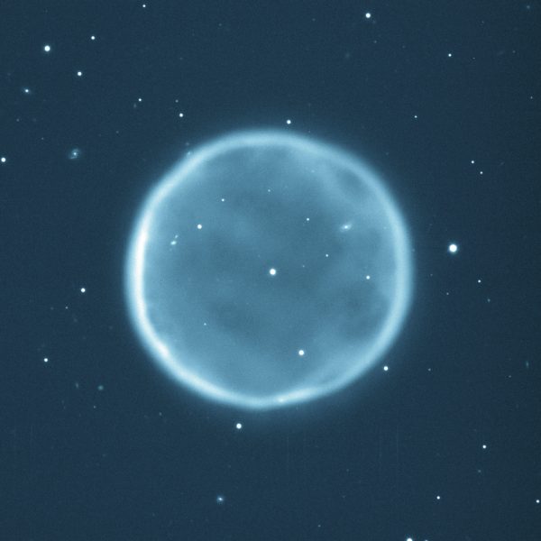 Abell 39, the 39th entry in a catalog of large nebulae discovered by George Abell in 1966, is a beautiful example of a planetary nebula. It was chosen for study by George Jacoby (WIYN Observatory), Gary Ferland (University of Kentucky), and Kirk Korista (Western Michigan University) because of its beautiful and rare spherical symmetry. This picture was taken at the WIYN Observatory's 3.5-m (138-inch) telescope at Kitt Peak National Observatory, Tucson, AZ, in 1997 through a blue-green filter that isolates the light emitted by oxygen atoms in the nebula at a wavelength of 500.7 nanometers. The nebula has a diameter of about five light-years, and the thickness of the spherical shell is about a third of a light-year. The nebula itself is roughly 7,000 light-years from Earth in the constellation Hercules. Credit: T.A.Rector (NRAO/AUI/NSF and NOAO/AURA/NSF) and B.A.Wolpa (NOAO/AURA/NSF)
