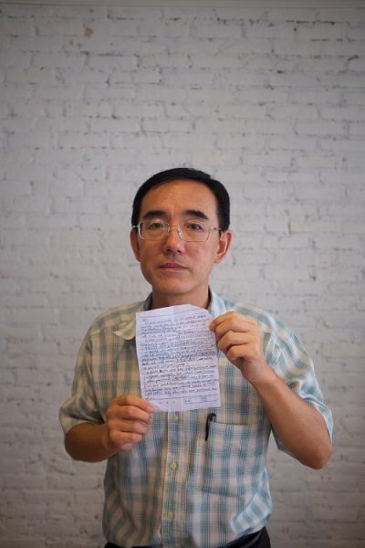 Sun Yi holds his SOS letter that he managed to get out of China's most notorious labor camp.