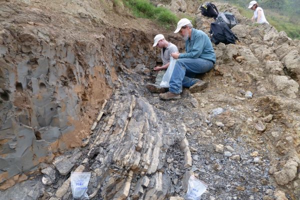 Sam Bowring (front) and former graduate student Seth Burgess inspect the End-Permian extinction horizon at Penglaitan. (Image: Image: Shuzhong Shen)