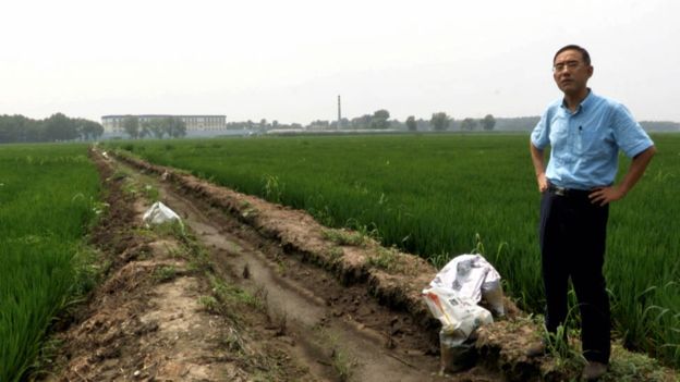 Sun Yi standing outside Masanjia in footage shot for the documentary. (Flying Cloud Productions)