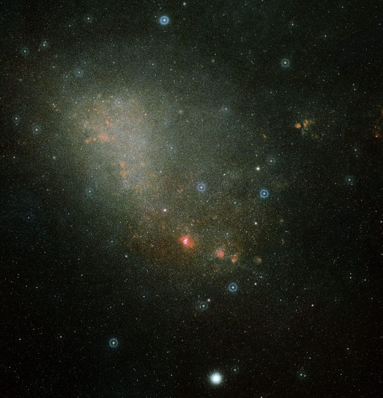This image shows an overview of the full Small Magellanic Cloud and was composed from two images from the Digitized Sky Survey 2, which digitized photographic surveys of the night sky. Image credit: Davide De Martin (ESA/Hubble)