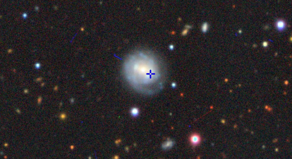Image from the Dark Energy Camera Legacy Survey (DECaLS) with cross hairs indicating the location of the AT2018cow event in the host galaxy, CGCG 127-68. Image credit: Color image from the Imagine Viewer, created by Dustin Lang, for the Legacy Surveys project (see legacysurvey.org/viewer).