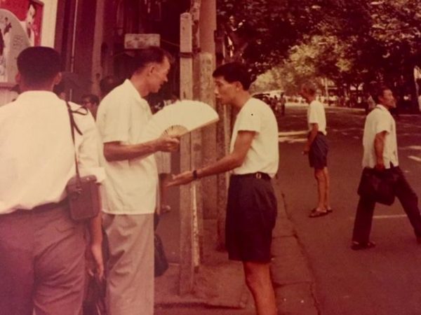 Two Chinese men conversations in an urban area of Shanghai