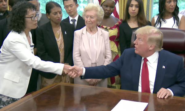 President Donald Trump shakes hands with Zhang Yuhua, a Falun Gong practitioner who survived persecution in China, at the White House on July 17, 2019. (Image: The White House)