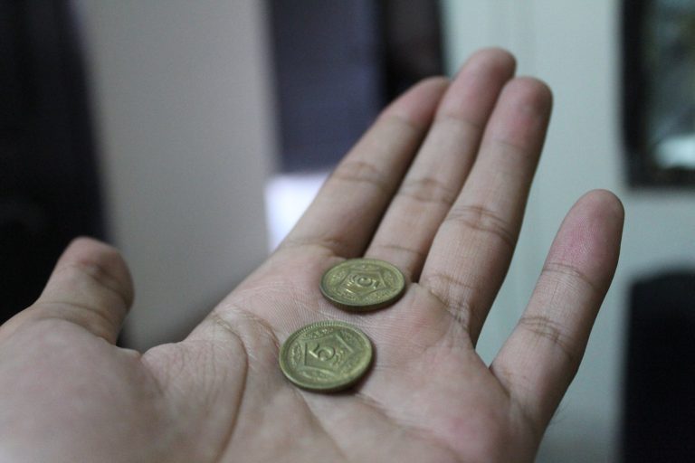 Two coins in a hand.