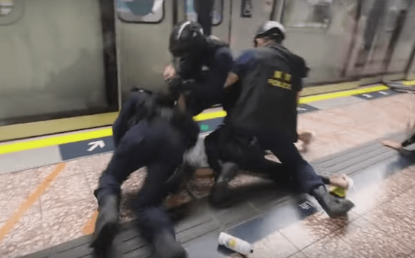 As the riot police stormed MTR trains, multiple people were hit with great force on the head and shown to be bleeding heavily. (Image: YouTube/Screenshot)