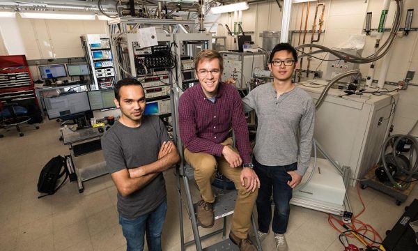 John Nichol and PhD students Yadav Kandel, left, and Haifeng Qiao, right, demonstrated a way to manipulate electrons and transmit information quantum-mechanically, bringing scientists one step closer to creating a fully functional quantum computer. Quantum computers will be able to perform complex calculations, factor extremely large numbers, and simulate the behaviors of atoms and particles at levels that classical computers cannot. (University of Rochester photo / J. Adam Fenster)