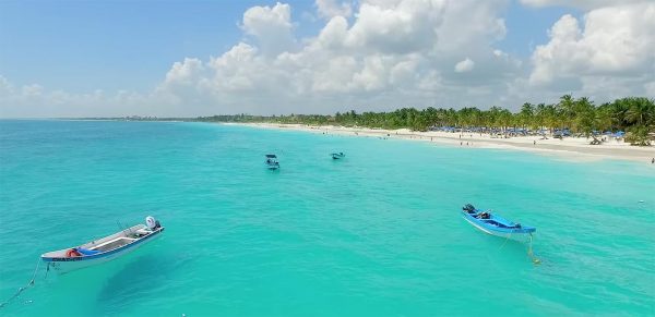Beach and coral-blue water, Tulum, Mexico.