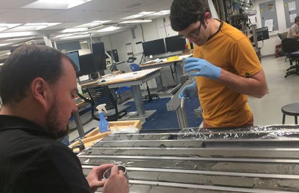 From left: Camilo Ponton, a former Earth sciences postdoc at USC Dornsife, and Valier Galy of Woods Hole Oceanographic Institution examine a sediment core sample. (Image: Jarrett Cruz and JOIDES Resolution Science Operator/ International Ocean Discovery Program.)