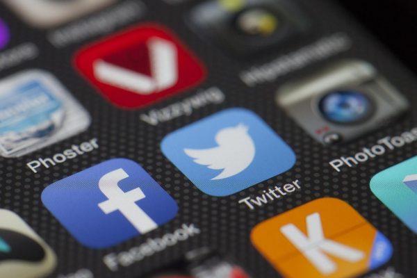 Facebook and Twitter app icons on a smartphone
