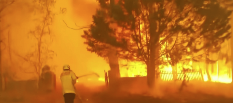 A firefighter battles the flames from an Australian wildfire.