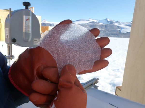 A thin section of an ice core collected at Taylor Glacier in Antarctica. The ice core samples contain tiny air bubbles with small quantities of ancient air trapped inside. The researchers use a melting chamber to extract the ancient air from the bubbles and then study its chemical composition. The Rochester research focused on measuring the composition of air from the time of Earth’s last deglaciation, 8,000-15,000 years ago. This time period is a partial analog to today. (University of Rochester photo/ Vasilii Petrenko)