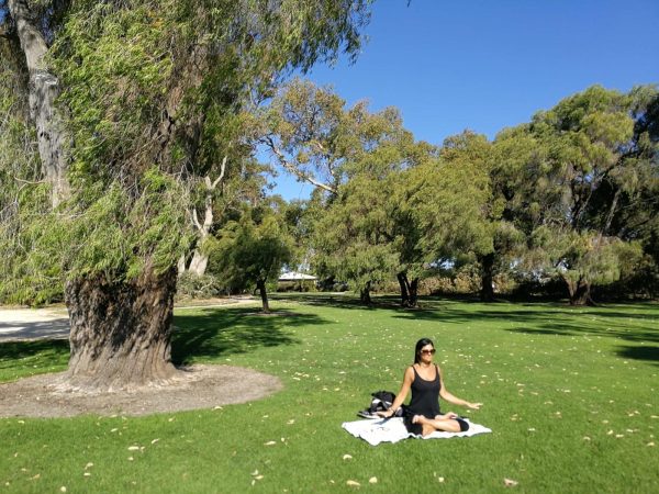 lady meditating under a tree