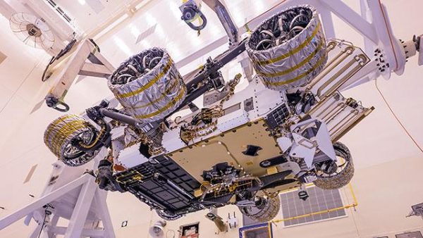 The Mars Helicopter, visible in lower center of the image, was attached to the belly of NASA's Perseverance rover at Kennedy Space Center on April 6, 2020. The helicopter will be deployed onto the Martian surface about two-and-a-half months after Perseverance lands. (Image: NASA/JPL-Caltech)