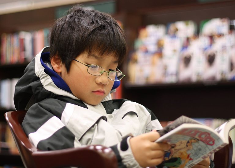 A young boy reading the manga Black Cat