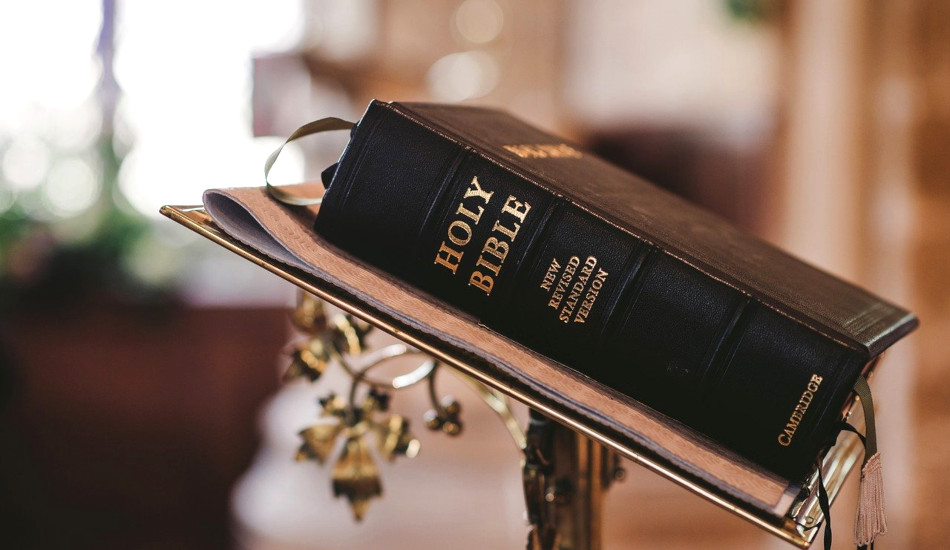 A bible sitting on a lectern.