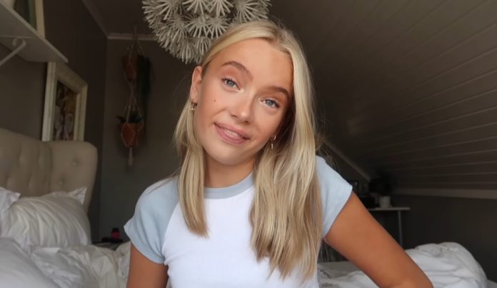 A girl films a video for her YouTube channel.