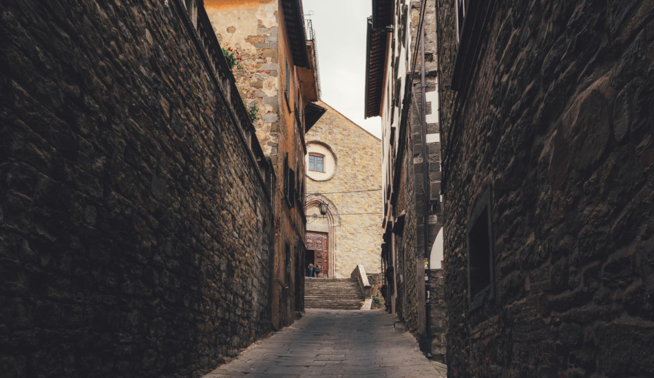 Alleyway between stone buildings.