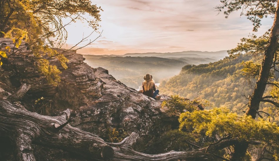 Woman sitting outside in the hills.
