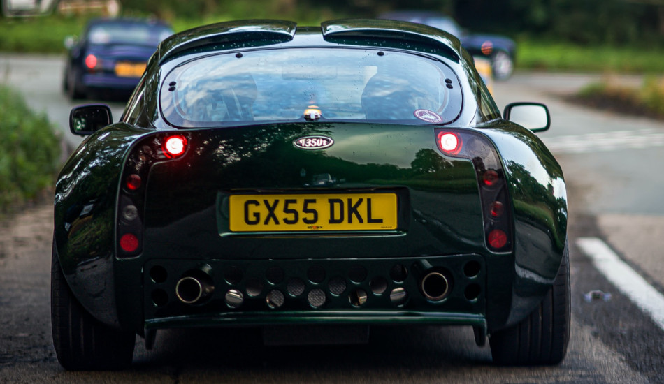 Green car with yellow license plate.