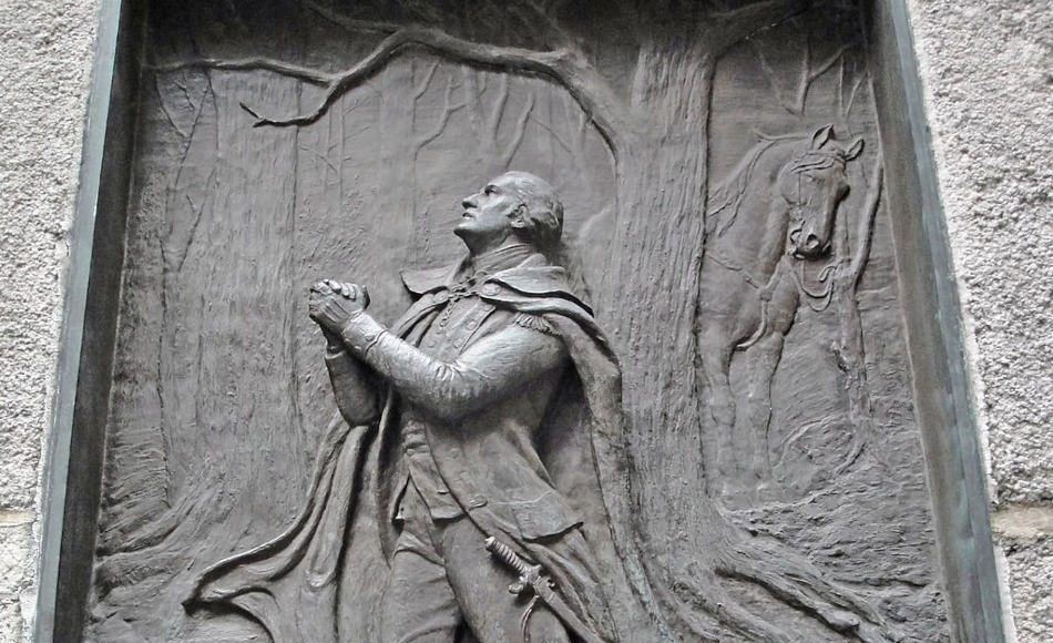 A brass relief of George Washington kneeling in prayer at Federal Hall in New York City.