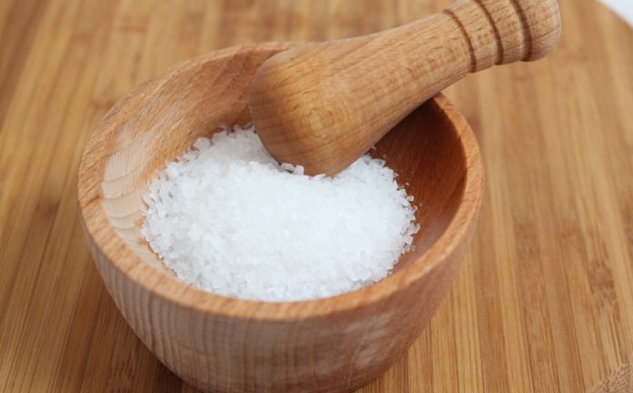 Sea salt with wooden mortar and pestle.