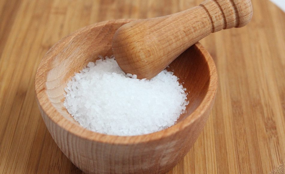 Sea salt with wooden mortar and pestle.