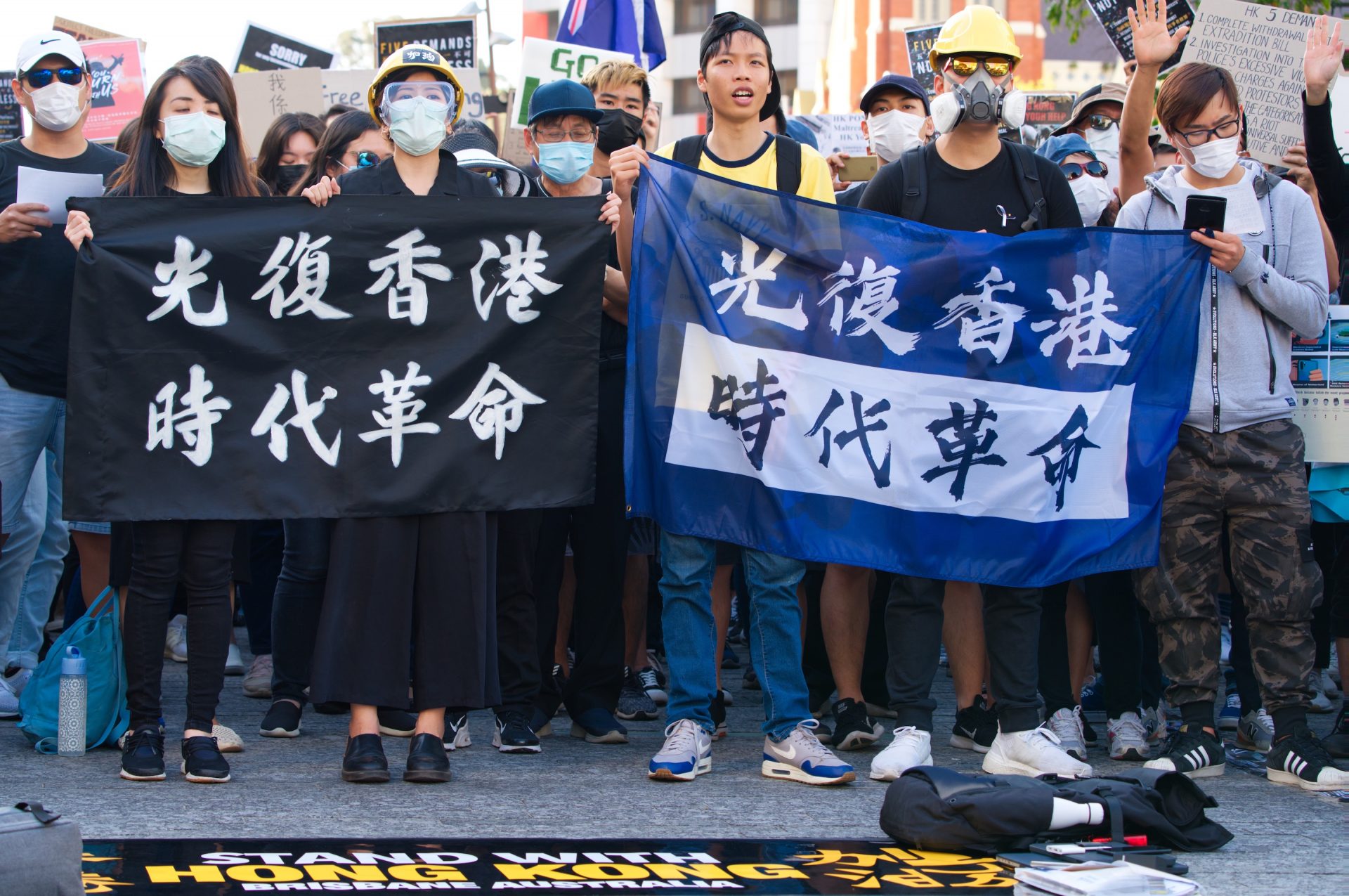 hong kong pro democracy generation y protesting, holding up a banner.