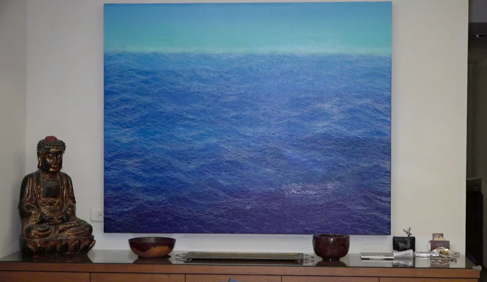 Some of the art in Stanton's home, a painting of blue ocean waves.