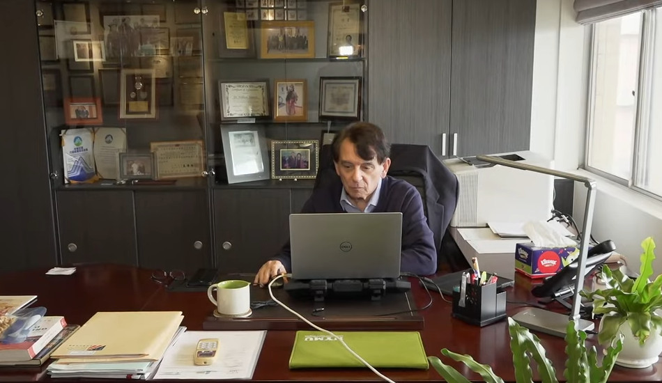 William Stanton working on a laptop in his office at National Yang Ming University.