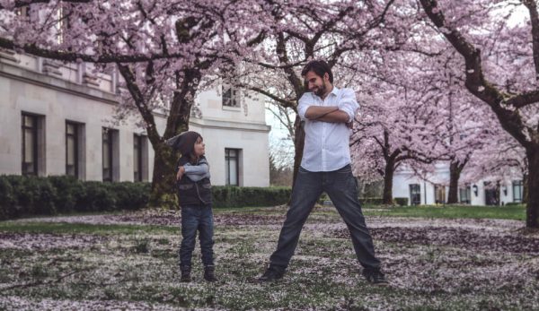 Father and son doing silly poses.