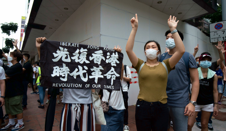 Protesters in Hong Kong with a banner reading: "Liberate Hong Kong, Revolution in Our Time".