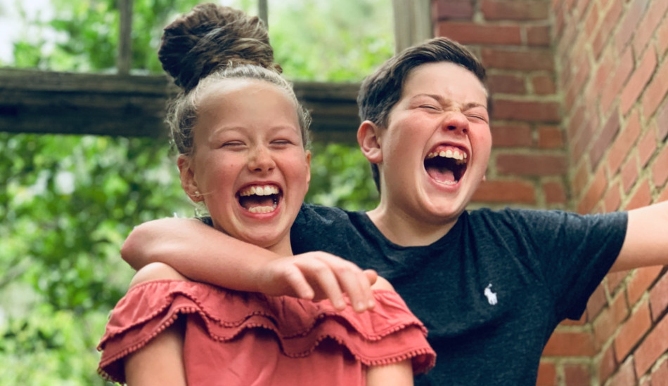 Girl and boy smiling.