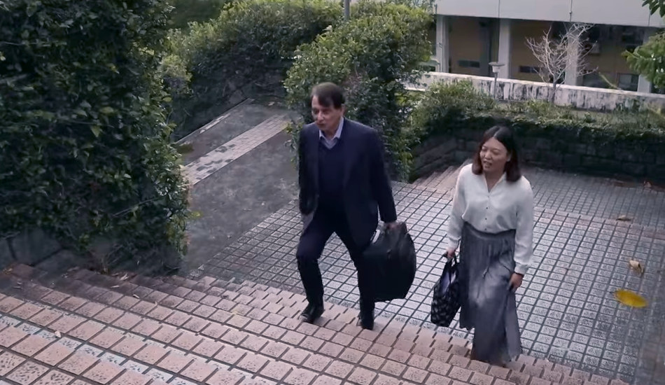 William Stanton climbing the stairs at National Yang Ming University with his secretary.