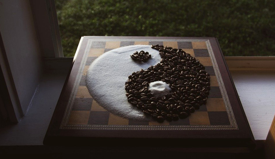 The yin-yang taiji symbol made from sugar and coffee beans.