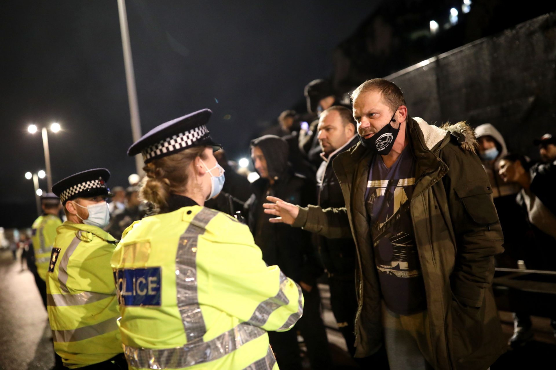 Police officers speak to a group of lorry drivers as the Port of Dover remains closed on December 22, 2020 in Dover, United Kingdom. Over 1500 lorries remained stacked up around Kent as drivers waited for a resumption of travel from the port of Dover to France. On Sunday, France abruptly halted freight and passenger travel from the UK over concerns about the UK's surging covid-19 cases and a new virus mutation.