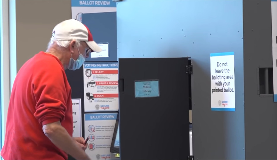 A man uses a voting machine.