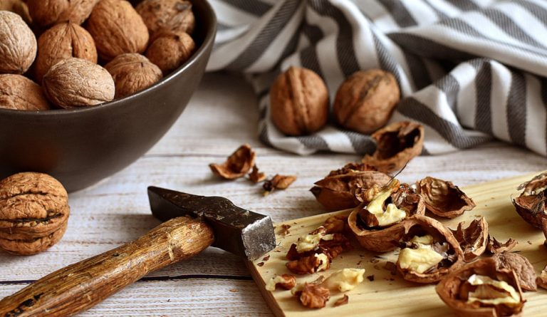 Cracking walnuts with a hammer.