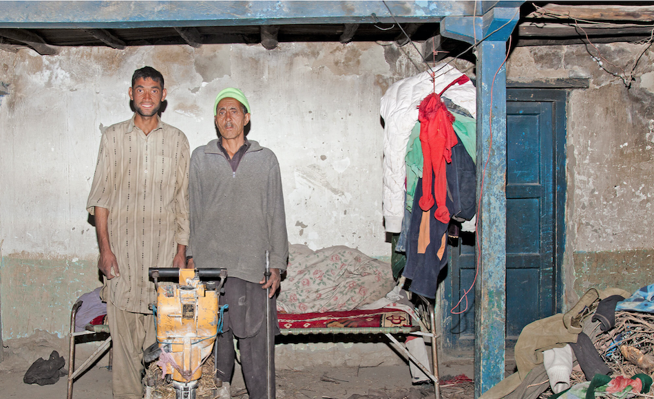 Miners Ibrahim Jalil and Gulam Nabi pose with a jackhammer in Hushe, Pakistan.
