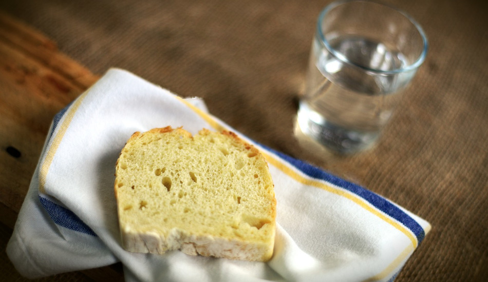 A piece of bread and a glass of water.