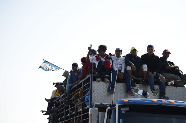 Central American migrants -mostly Honduran- taking part in a caravan to the US, are pictured on board a truck heading to Irapuato in the state of Guanajuato on November 11, 2018 after spending the night in Queretaro in central Mexico. - The United States embarked Friday on a policy of automatically rejecting asylum claims of people who cross the Mexican border illegally in a bid to deter Central American migrants and force Mexico to handle them. (Image: ALFREDO ESTRELLA/AFP via Getty Images)